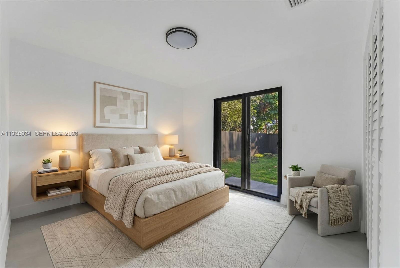 5821 Northwest 30th Avenue Miami, FL 33142 - Photo 6 of 14 a bedroom with a bed and a couch