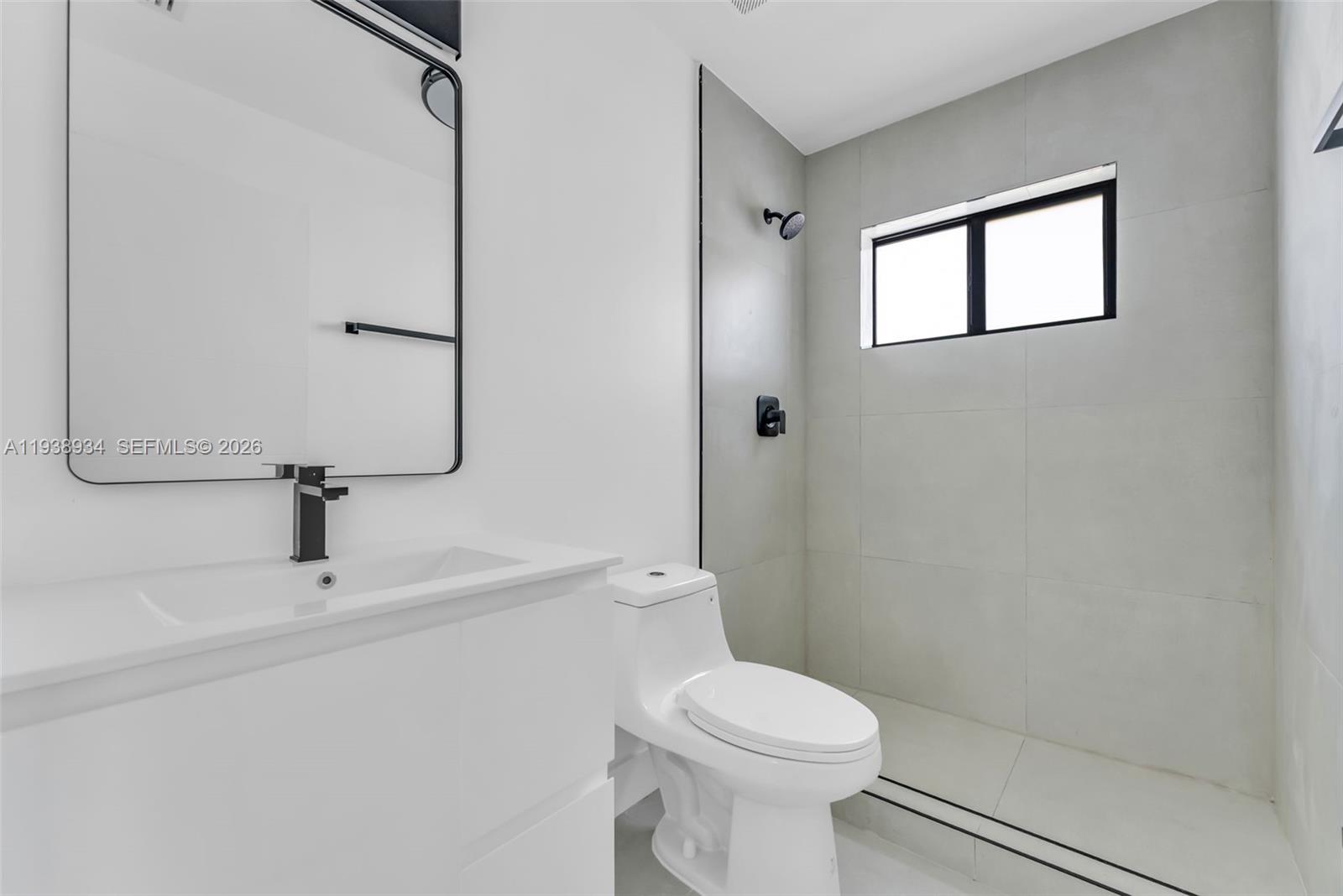 5821 Northwest 30th Avenue Miami, FL 33142 - Photo 8 of 14 a white toilet sitting next to a bathroom sink