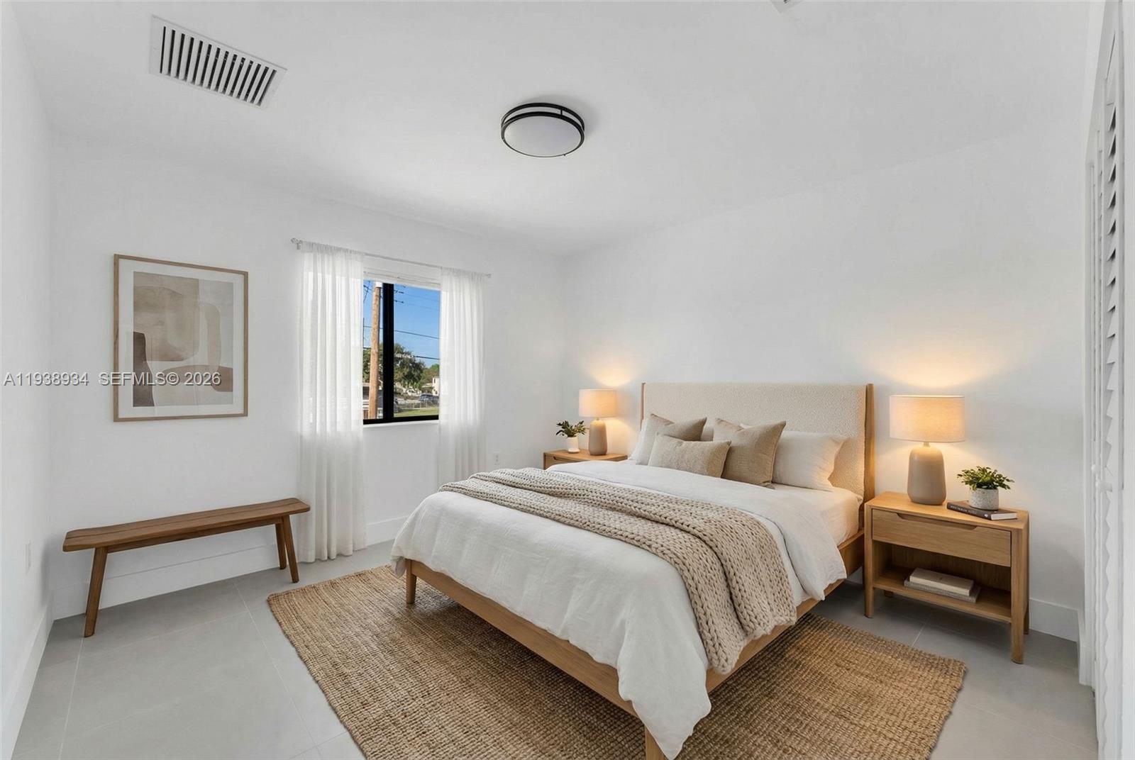 5821 Northwest 30th Avenue Miami, FL 33142 - Photo 10 of 14 a bedroom with a bed and a lamp on table