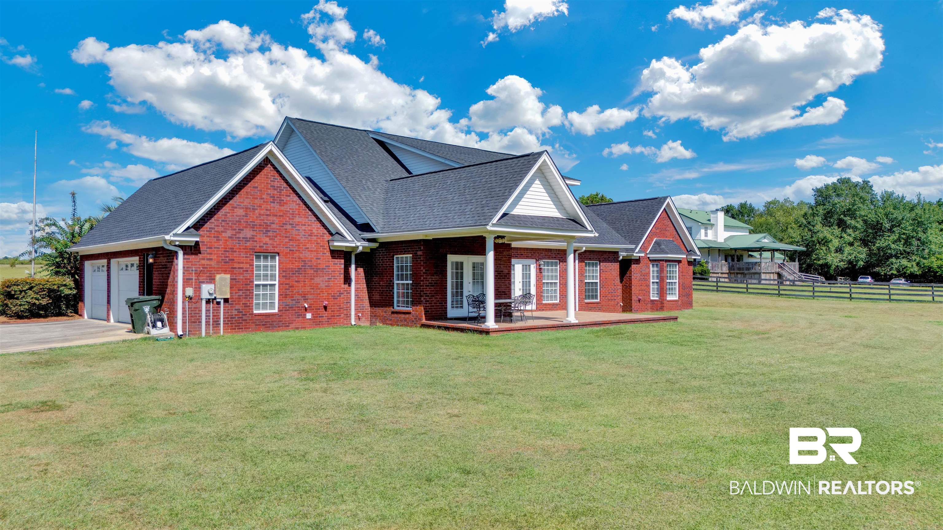 27688 Rigsby Road Daphne, AL 36526 - Photo 51 of 56 Rear view of house featuring a yard and a garage