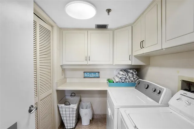 a bedroom with two beds and a chandelier