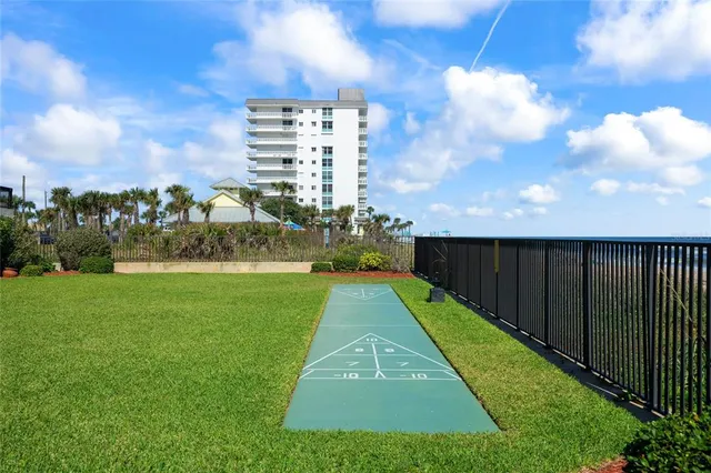 a living room with furniture a flat screen tv and a ceiling fan