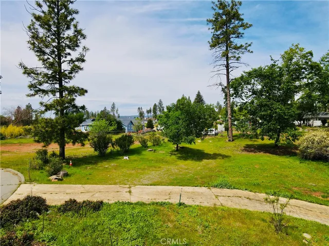 a view of a garden with a building in the background