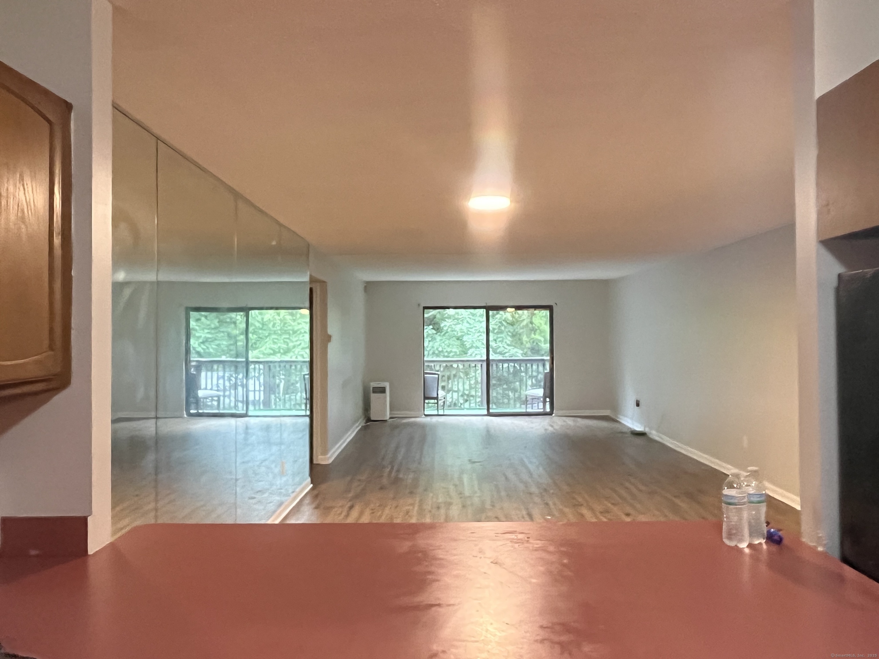 1274 East Main Street, Unit D27 Meriden, CT 06450 - Photo 2 of 2 an empty room with wooden floor and windows