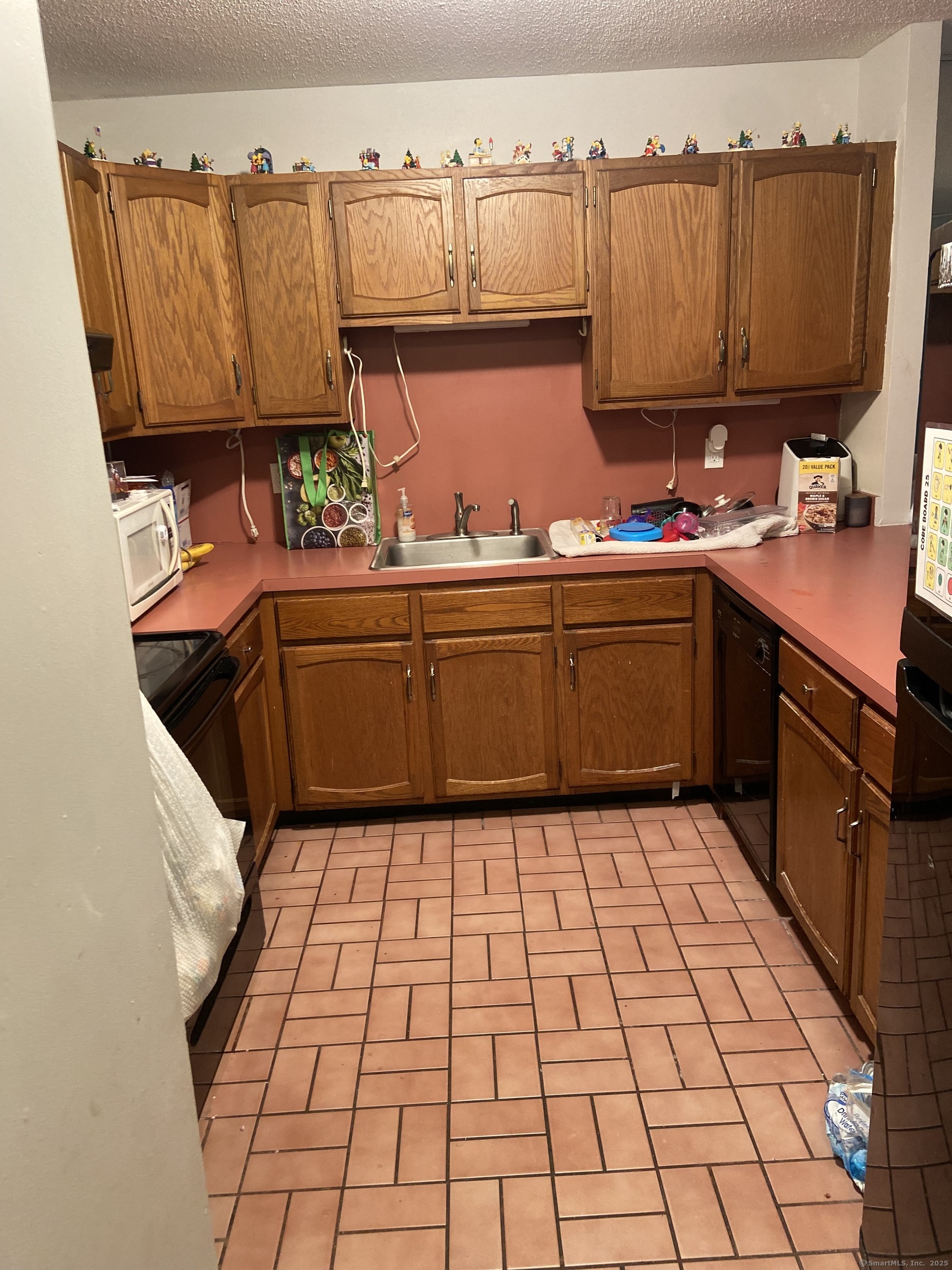1274 East Main Street, Unit D27 Meriden, CT 06450 - Photo 2 of 2 a kitchen with stainless steel appliances granite countertop a sink and cabinets