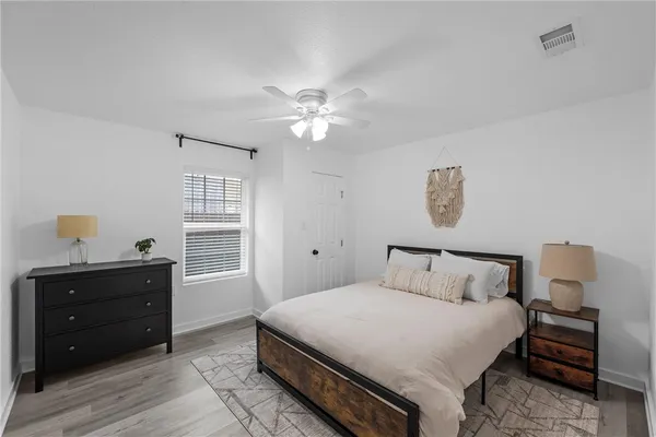 a bedroom with a bed and a window