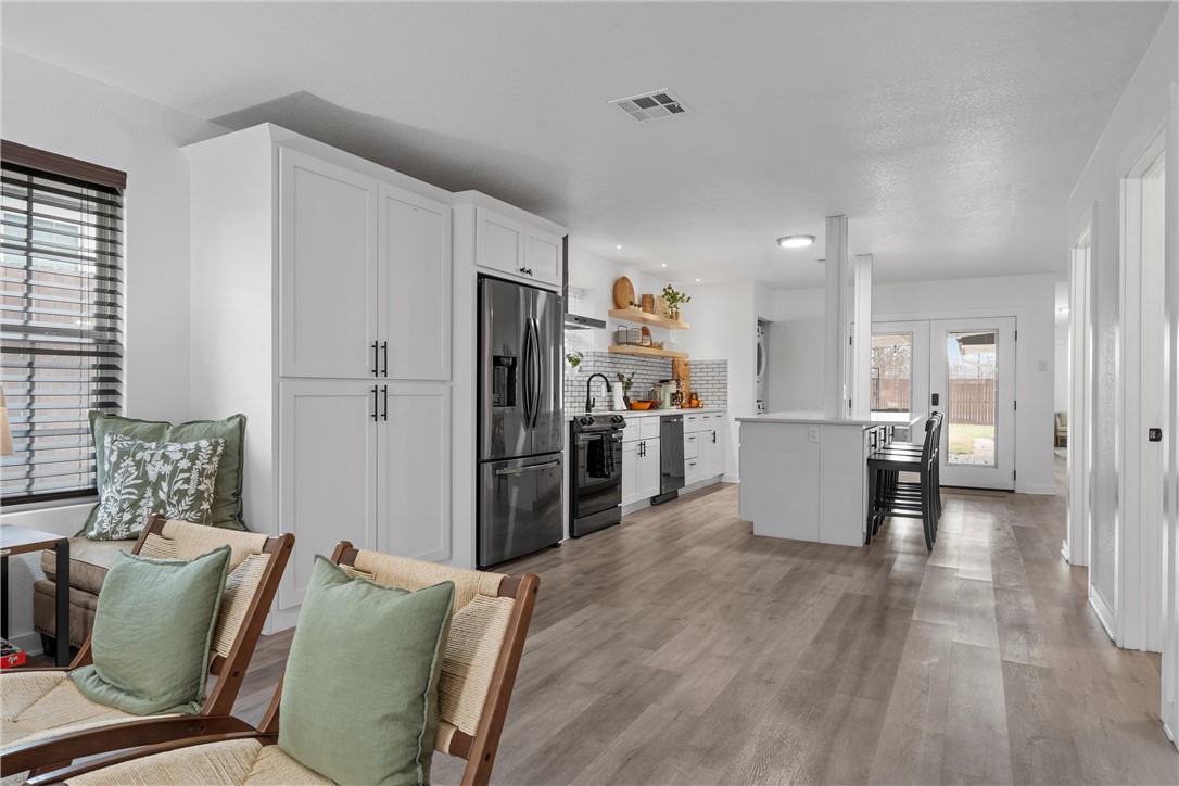 621 South 9th Street Waco, TX 76706 - Photo 6 of 31 a living room with furniture and a refrigerator