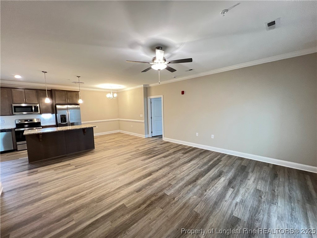 260 Gallery Drive, Unit 101 Spring Lake, NC 28390 - Photo 11 of 31 a view of kitchen and empty room with wooden floor