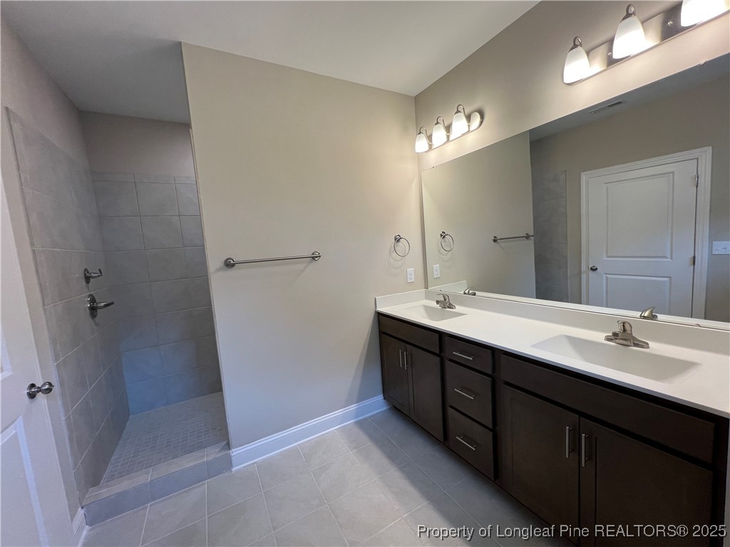 260 Gallery Drive, Unit 101 Spring Lake, NC 28390 - Photo 15 of 31 a bathroom with a double vanity sink a and mirror