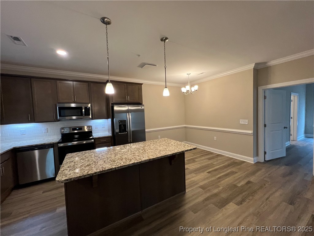 260 Gallery Drive, Unit 101 Spring Lake, NC 28390 - Photo 6 of 31 a large kitchen with kitchen island a counter space a sink and appliances
