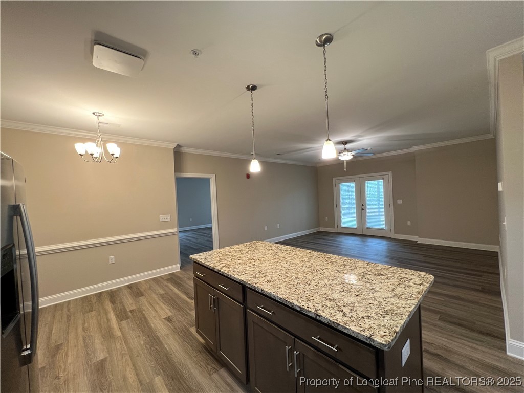 260 Gallery Drive, Unit 101 Spring Lake, NC 28390 - Photo 10 of 31 a kitchen with kitchen island a counter top space appliances and a ceiling fan