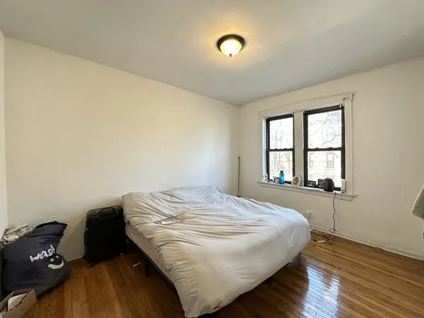 a bedroom with a bed and a large window