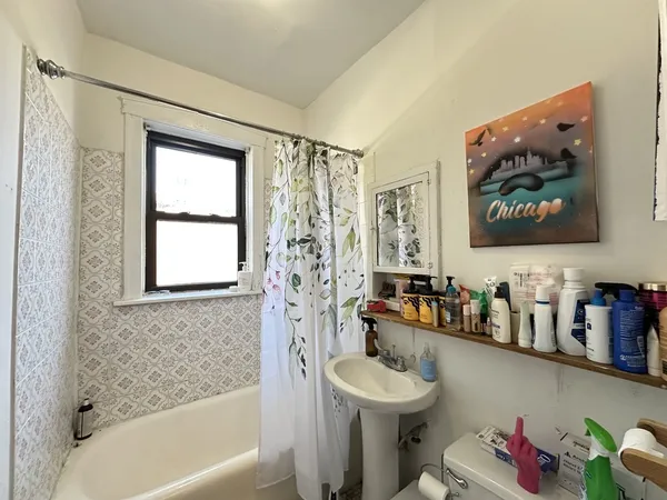 a bathroom with a sink mirror bathtub and toilet