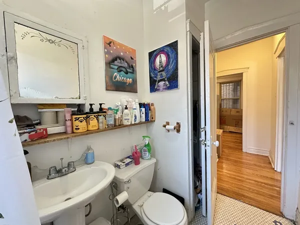 a bathroom with a sink a toilet and a shower curtain