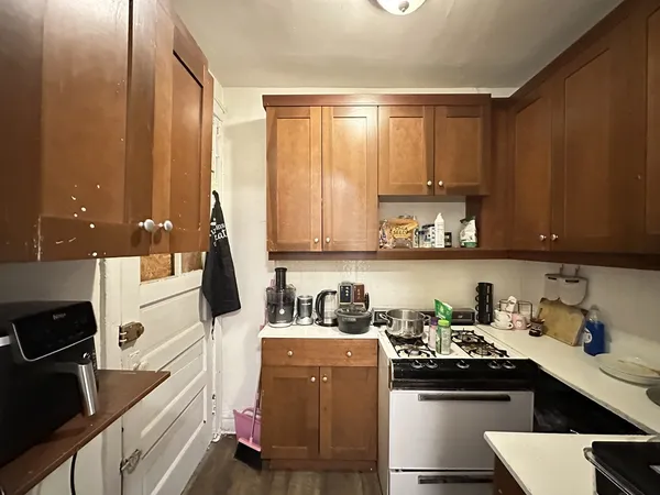 a kitchen with a sink cabinets and window