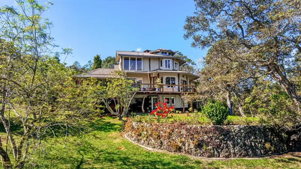 a view of a house with a yard and garden