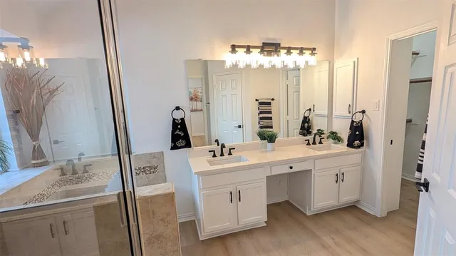 a bathroom with a tub sink and mirror