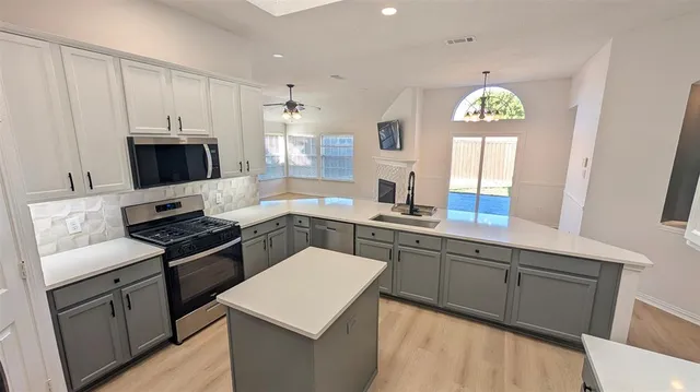 a kitchen with a sink stove and microwave