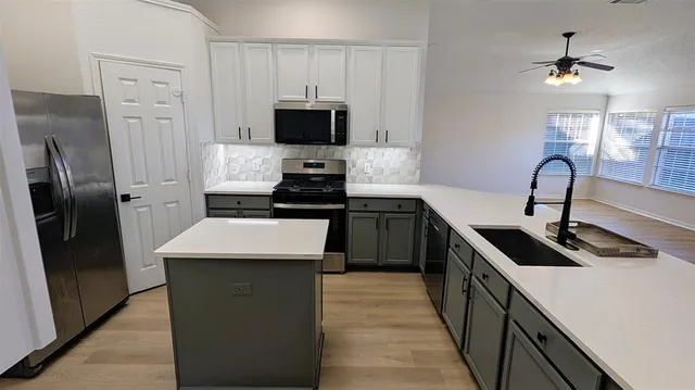 a kitchen with a sink stove and refrigerator