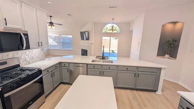 a kitchen with a sink stove and microwave
