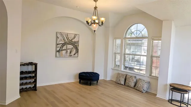 a view of a livingroom with a window and wooden floor