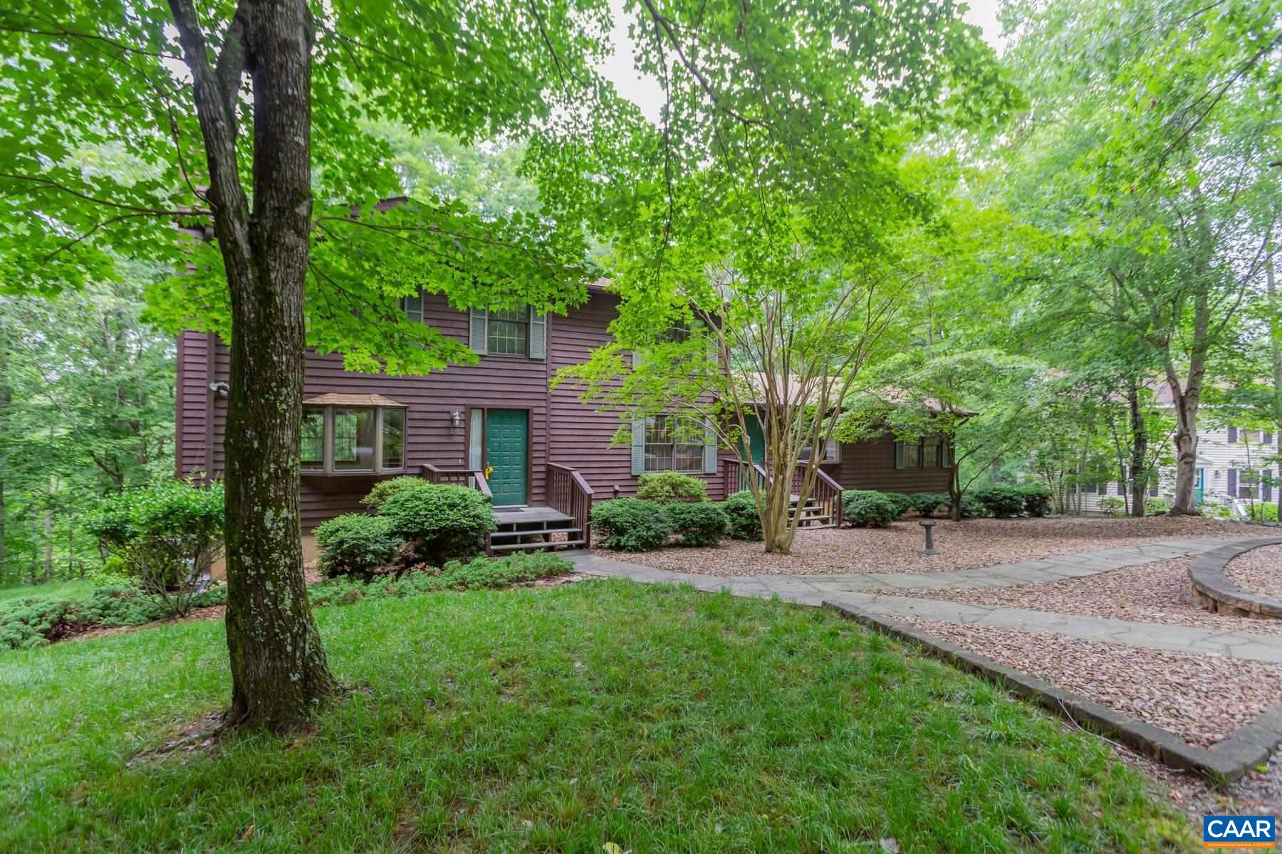 a view of a house with a yard and tree s