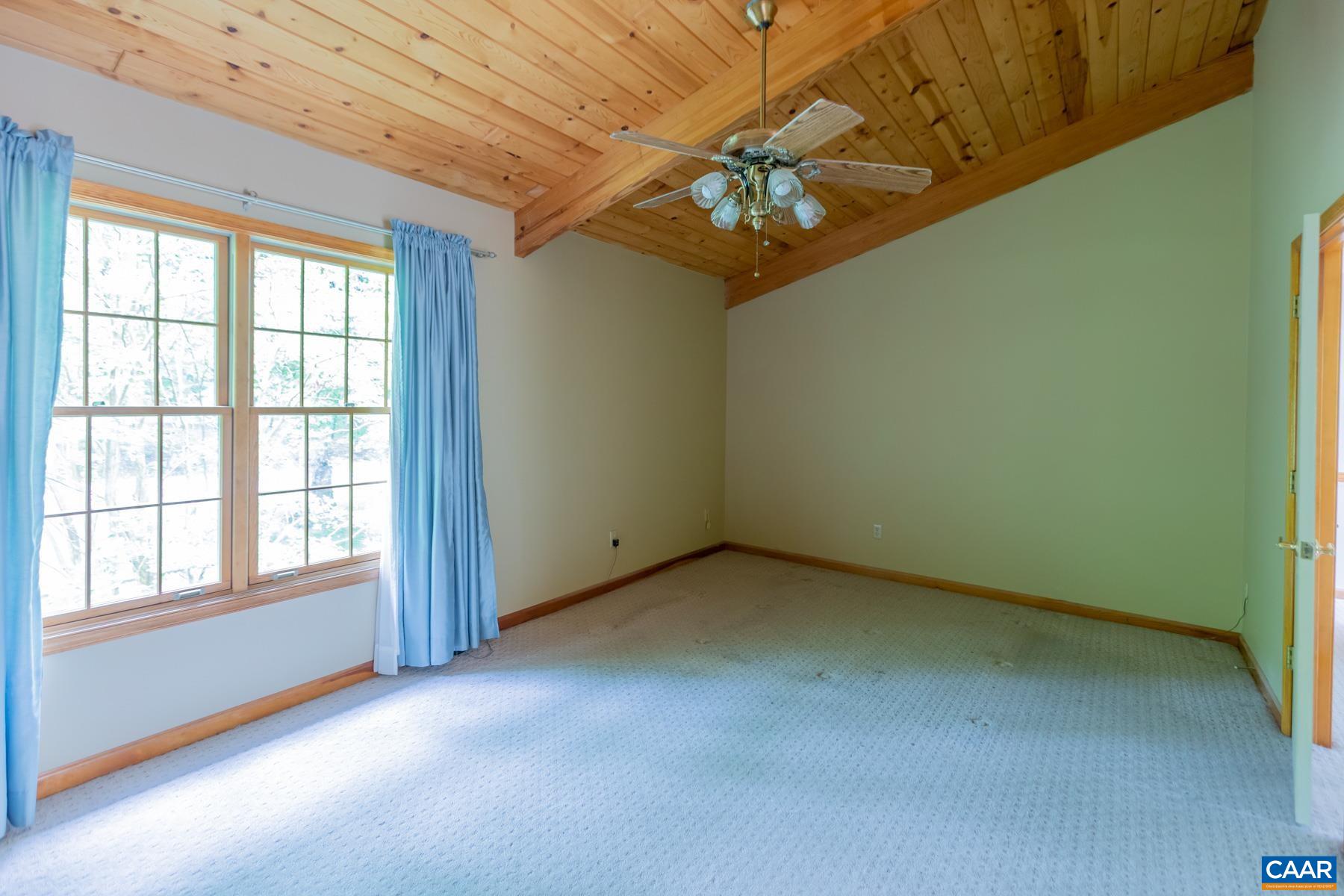 21 Briarwood Road Palmyra, VA 22963 - Photo 18 of 37 an empty room with a chandelier fan and windows