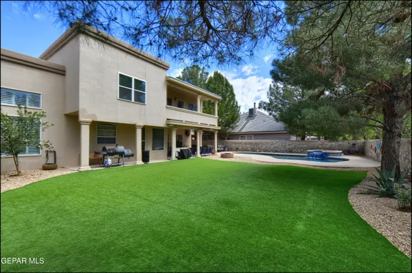 a view of house with yard and outdoor seating