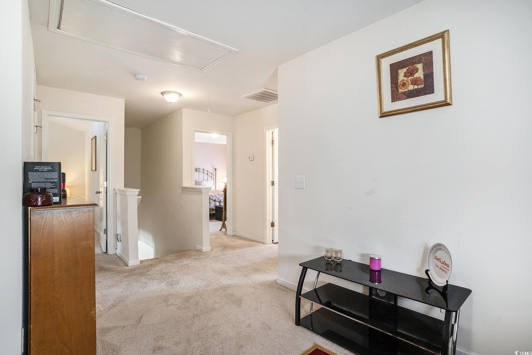763 Trap Shooter Circle Longs, SC 29568 - Photo 14 of 37 Corridor featuring an upstairs landing, light colored carpet, and attic access