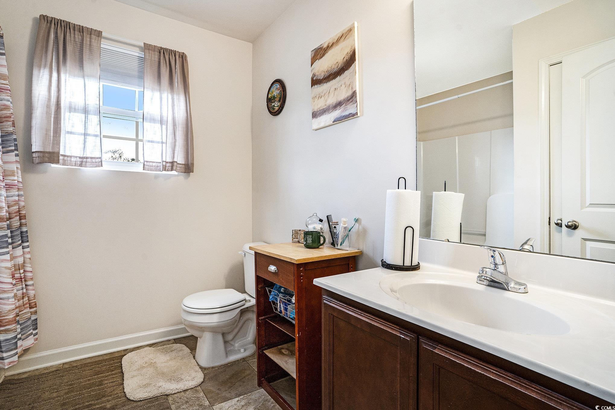 763 Trap Shooter Circle Longs, SC 29568 - Photo 25 of 37 Bathroom with vanity and a shower with curtain