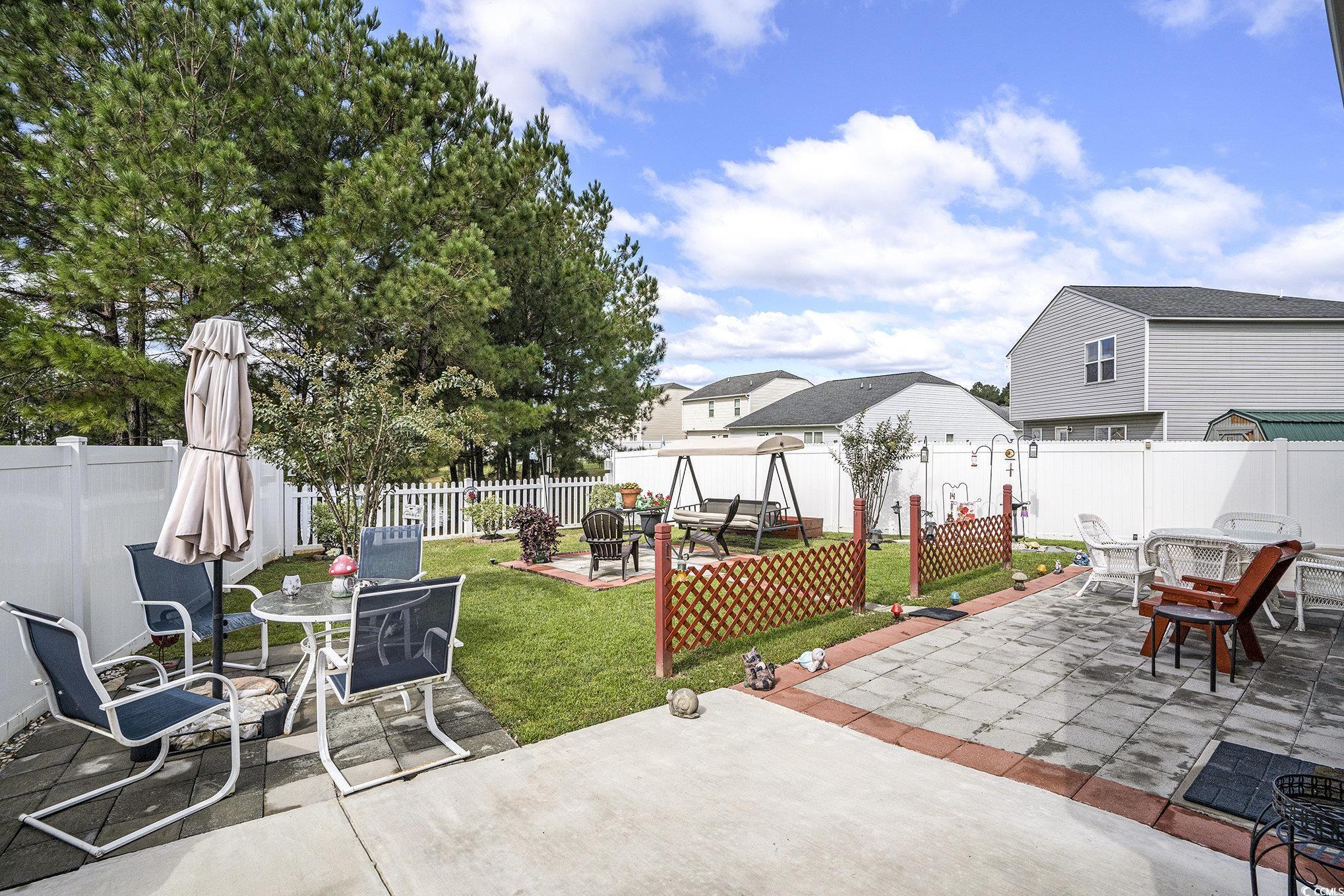 763 Trap Shooter Circle Longs, SC 29568 - Photo 29 of 37 Fenced backyard featuring outdoor dining area and a patio