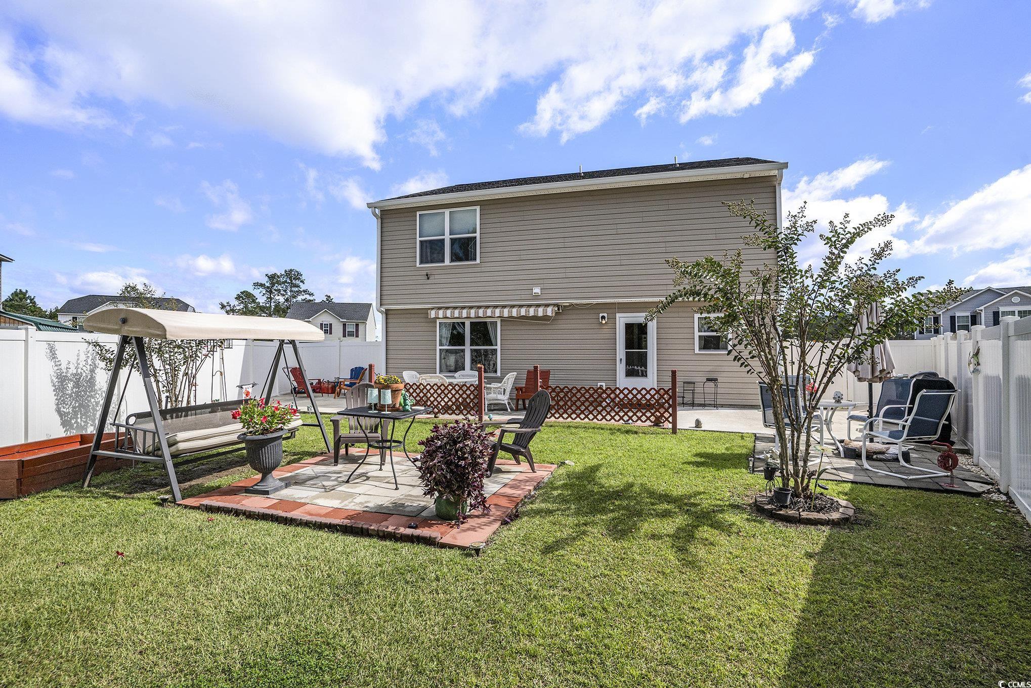 763 Trap Shooter Circle Longs, SC 29568 - Photo 30 of 37 Back of house featuring a fenced backyard and a patio area