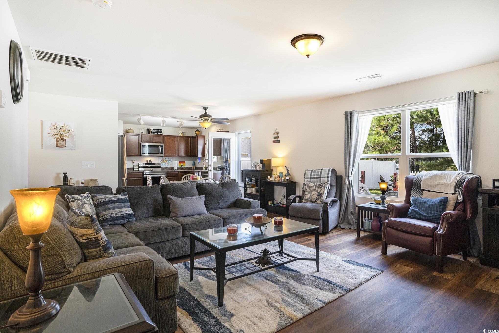 763 Trap Shooter Circle Longs, SC 29568 - Photo 7 of 37 Living area featuring dark wood-style floors and a ceiling fan