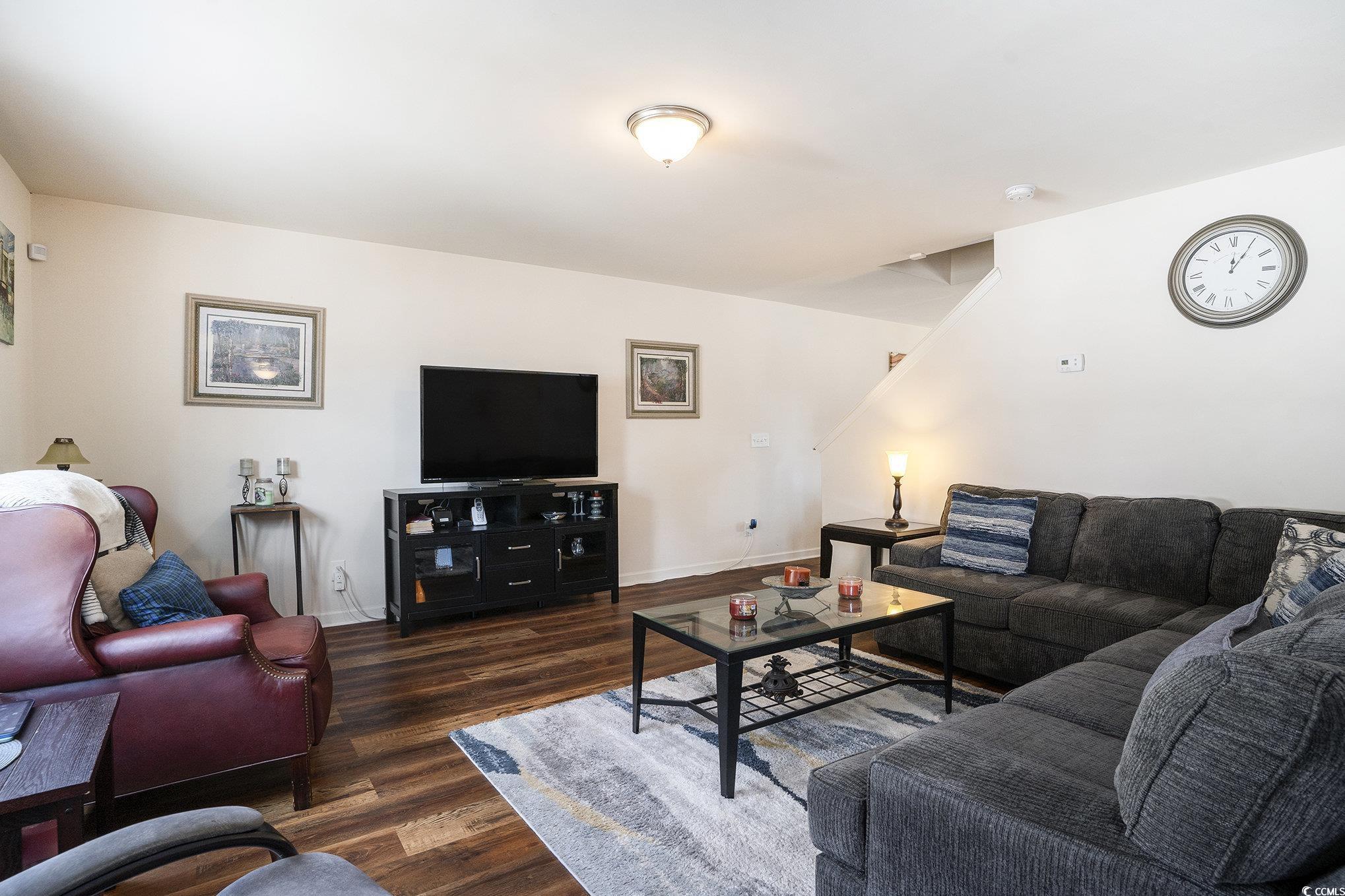 763 Trap Shooter Circle Longs, SC 29568 - Photo 8 of 37 Living area with dark wood finished floors and baseboards