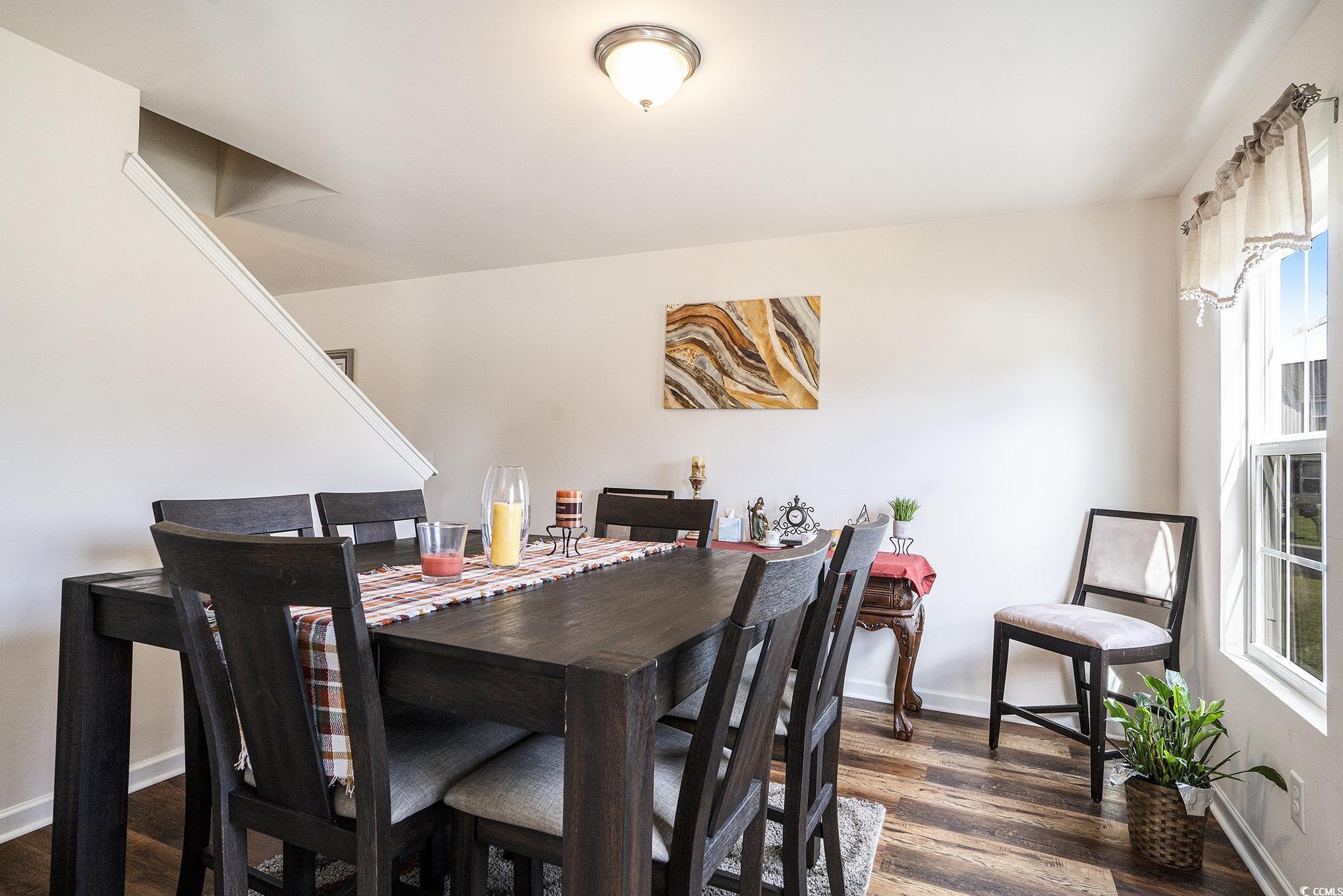 763 Trap Shooter Circle Longs, SC 29568 - Photo 9 of 37 Dining area featuring dark wood-style floors and baseboards