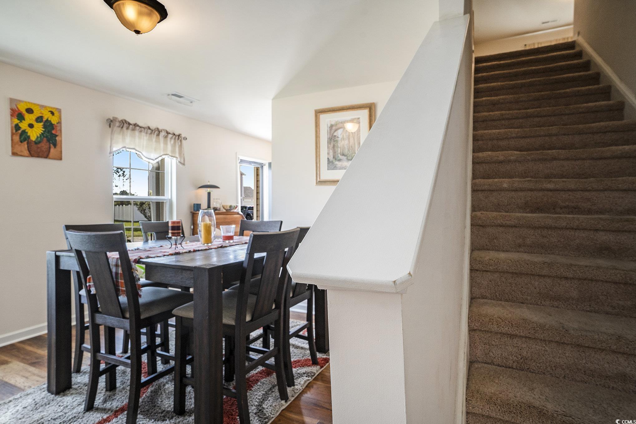 763 Trap Shooter Circle Longs, SC 29568 - Photo 10 of 37 Dining area with dark wood finished floors and baseboards