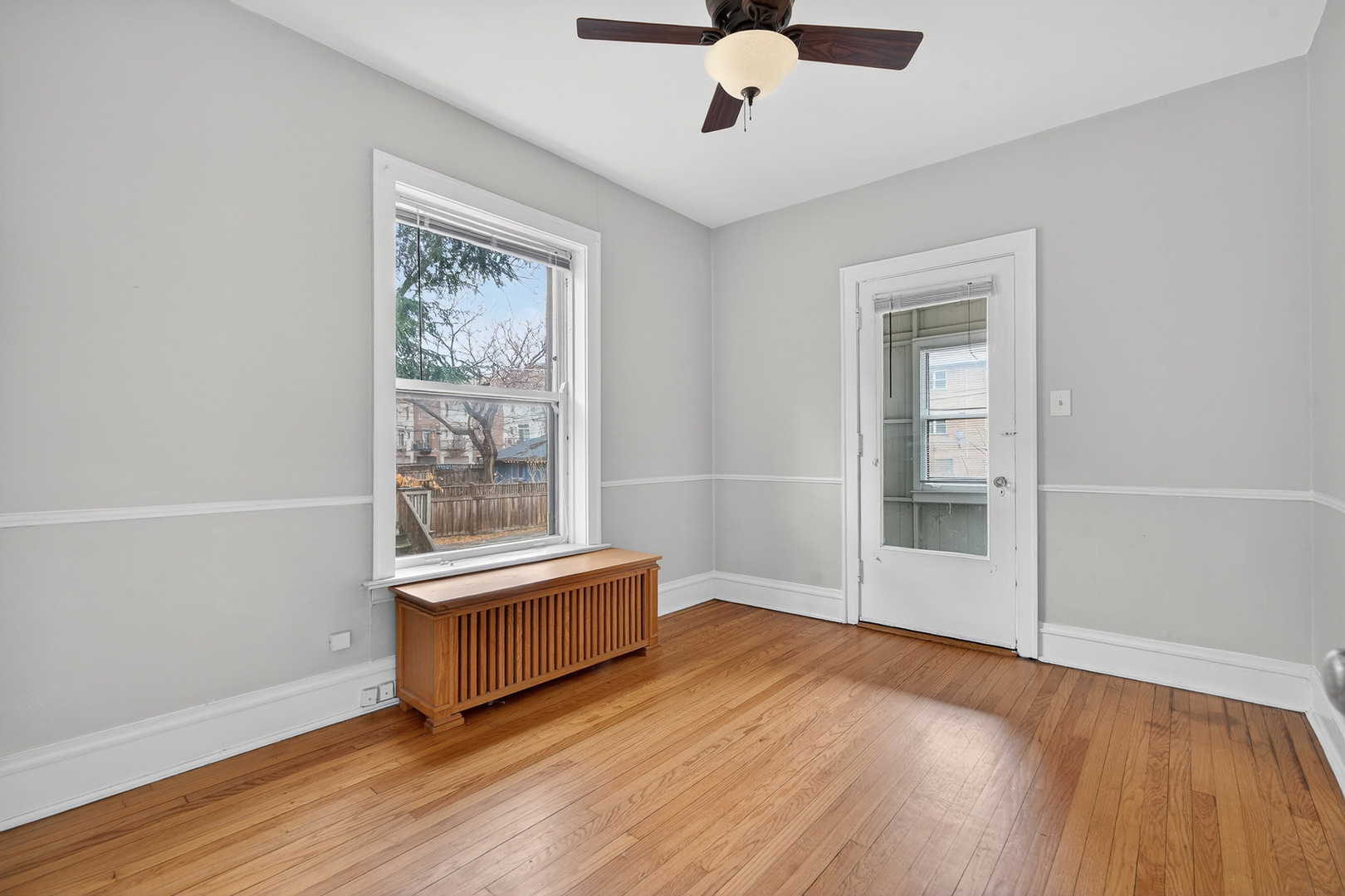 344 Wisconsin Avenue, Unit 1 Oak Park, IL 60302 - Photo 14 of 20 an empty room with wooden floor fan and windows