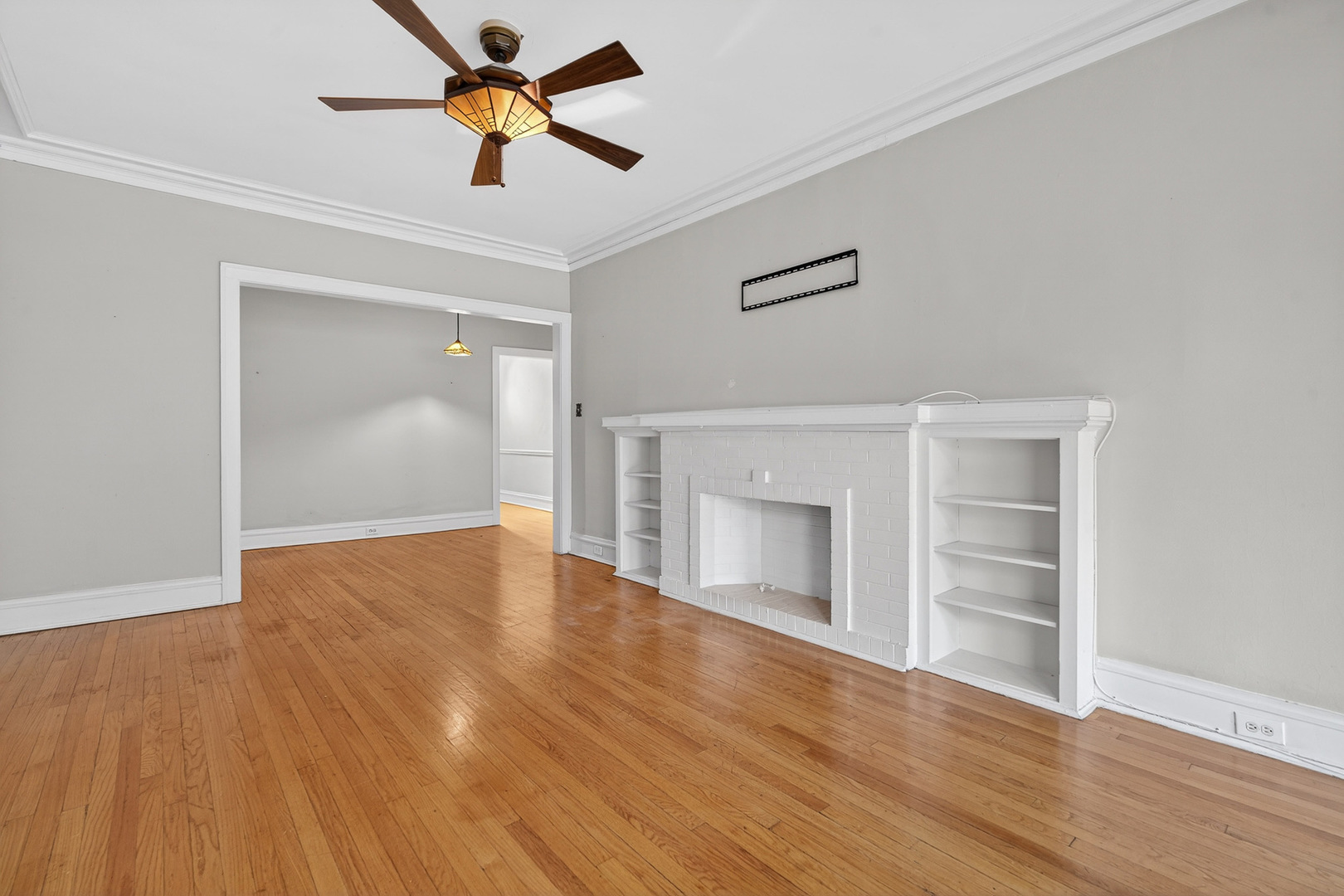 344 Wisconsin Avenue, Unit 1 Oak Park, IL 60302 - Photo 5 of 20 a view of empty room with wooden floor and fan
