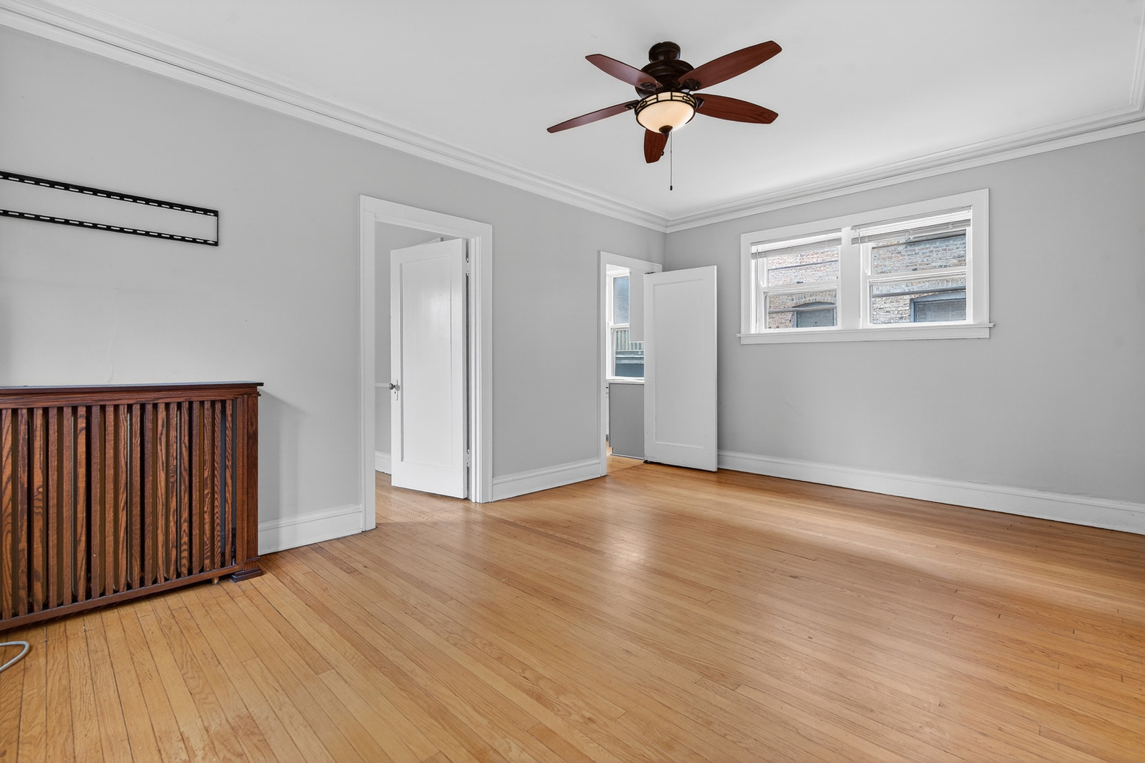 344 Wisconsin Avenue, Unit 1 Oak Park, IL 60302 - Photo 7 of 20 a view of empty room with wooden floor and fan