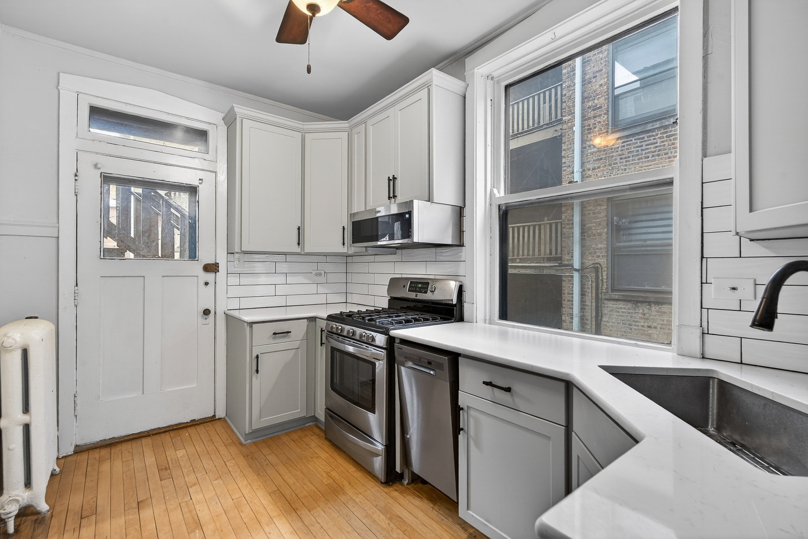344 Wisconsin Avenue, Unit 1 Oak Park, IL 60302 - Photo 8 of 20 a kitchen with stainless steel appliances granite countertop a stove and a sink
