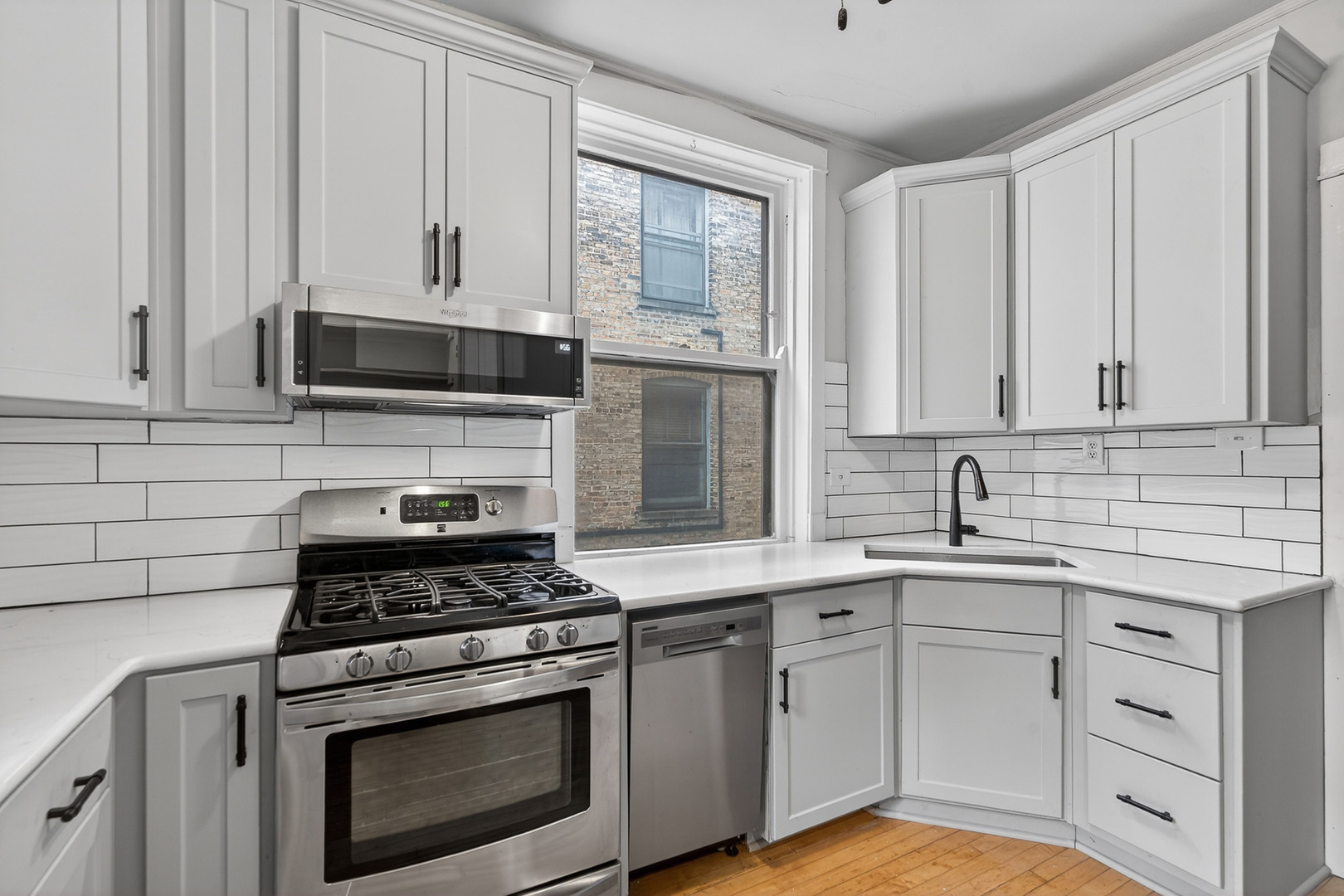 344 Wisconsin Avenue, Unit 1 Oak Park, IL 60302 - Photo 9 of 20 a kitchen with cabinets stainless steel appliances and a sink