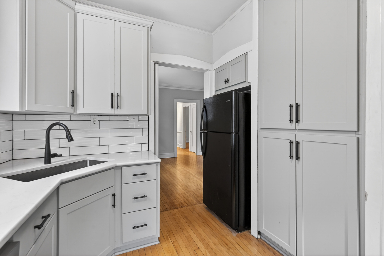 344 Wisconsin Avenue, Unit 1 Oak Park, IL 60302 - Photo 10 of 20 a kitchen with white cabinets and refrigerator