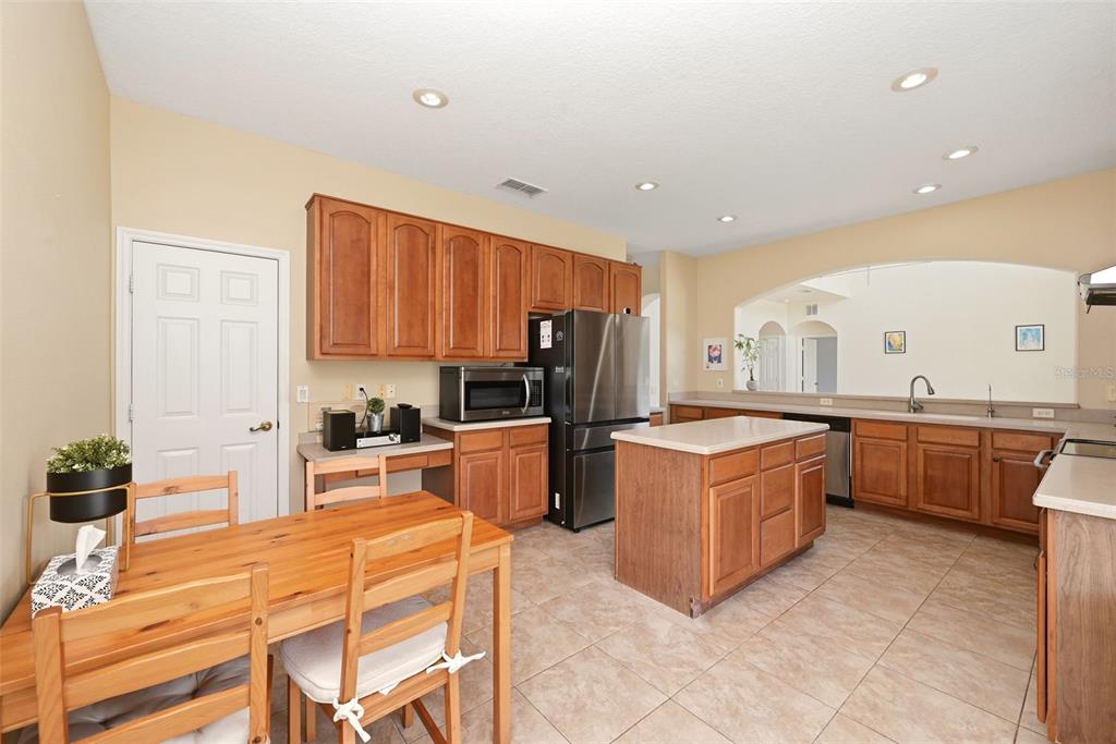 936 Kingsridge Circle Gotha, FL 34734 - Photo 43 of 50 a large kitchen with stainless steel appliances granite countertop a stove refrigerator and a sink
