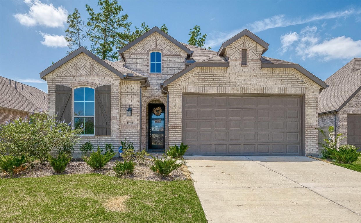 15714 Autumn Sun Conroe, TX 77302 - Photo 1 of 31 a front view of a house with garden