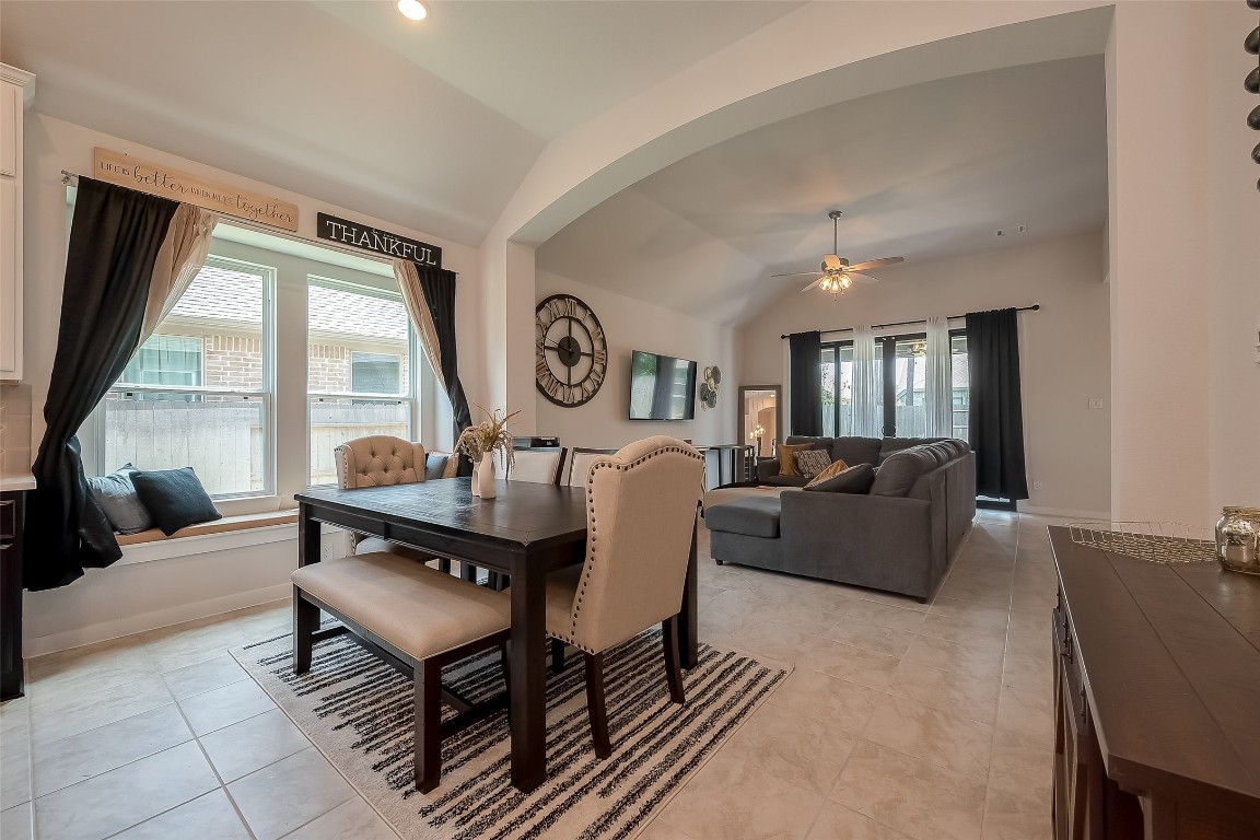 15714 Autumn Sun Conroe, TX 77302 - Photo 16 of 31 a living room with furniture a large window and a clock