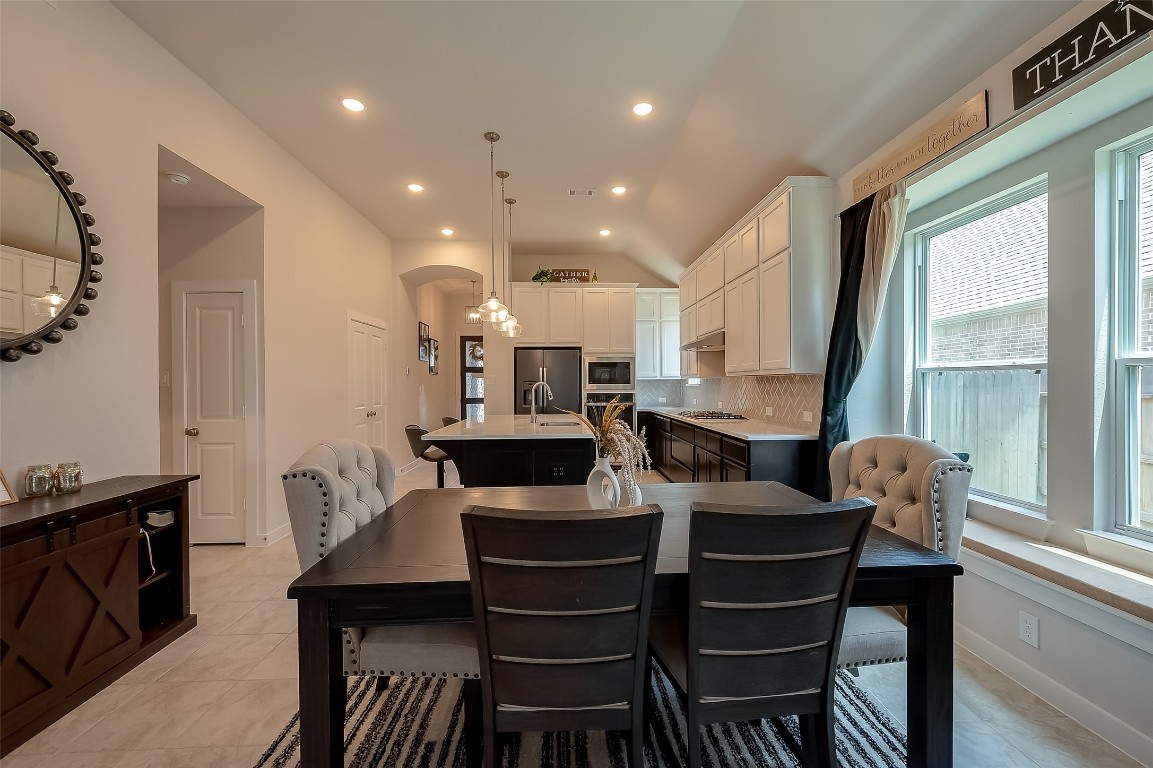 15714 Autumn Sun Conroe, TX 77302 - Photo 17 of 31 a view of a dining room with furniture and a large window