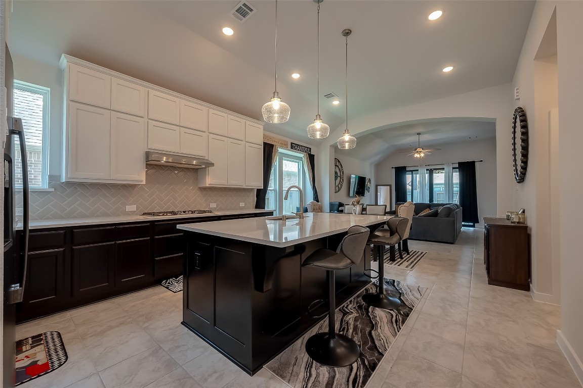 15714 Autumn Sun Conroe, TX 77302 - Photo 23 of 31 a kitchen with counter space dining table and chairs