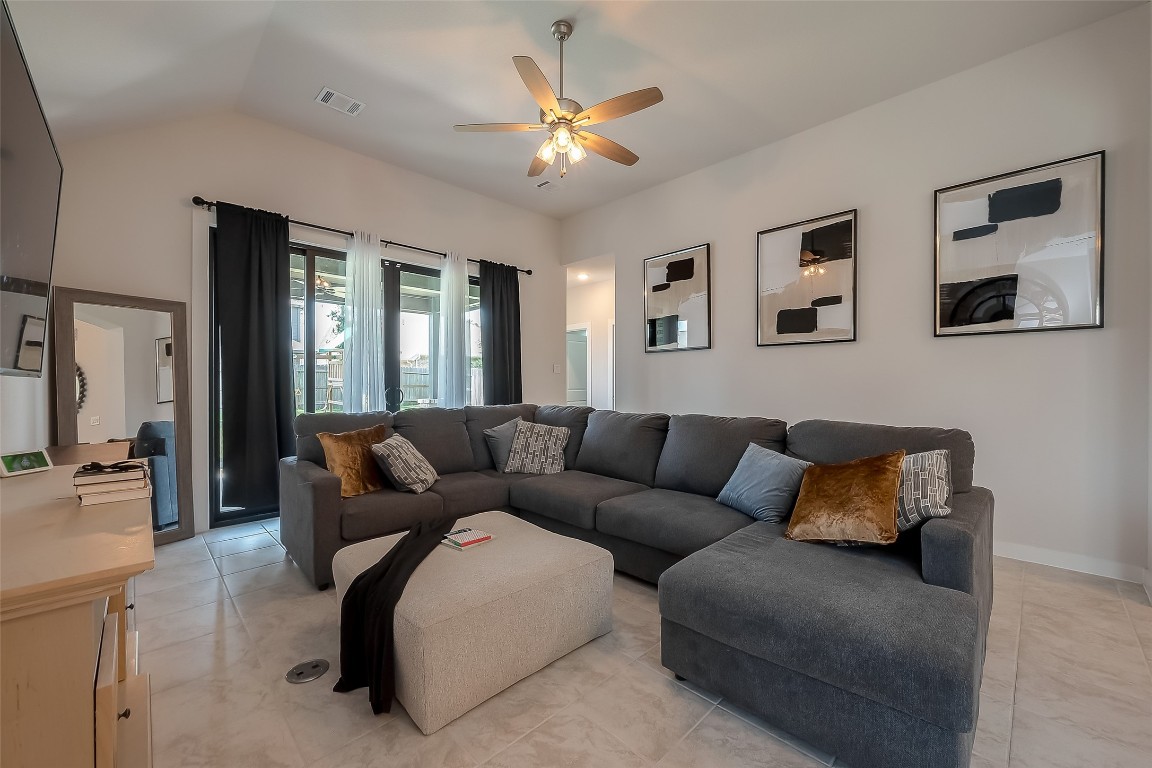 15714 Autumn Sun Conroe, TX 77302 - Photo 24 of 31 a living room with furniture and a ceiling fan