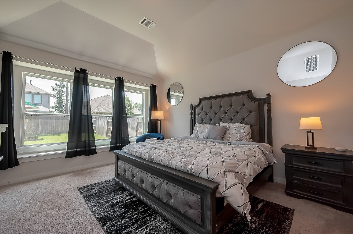 15714 Autumn Sun Conroe, TX 77302 - Photo 26 of 31 a bedroom with a large bed and a large window