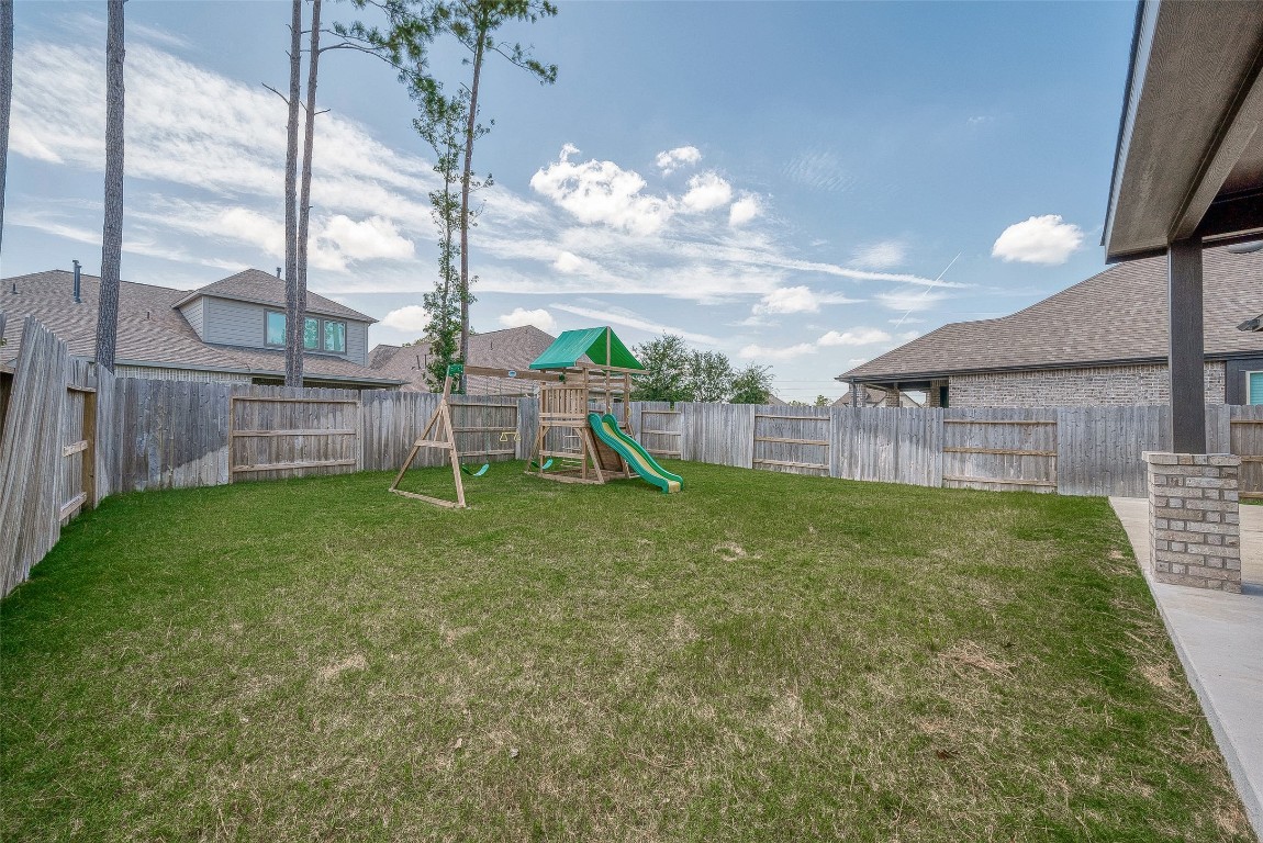 15714 Autumn Sun Conroe, TX 77302 - Photo 30 of 31 a view of a house with a backyard